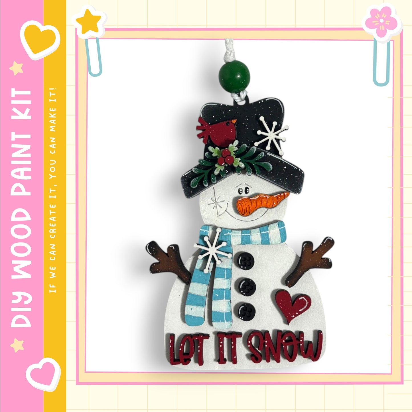 A snowman ornament with a hat, scarf, and carrot nose, along with the text "LET IT SNOW" on its body.