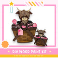 a DIY wood paint kit with a wooden basket containing a large wooden toy with horns and a smaller wooden toy. The kit appears to be made of wood and is designed for creating wooden toys.