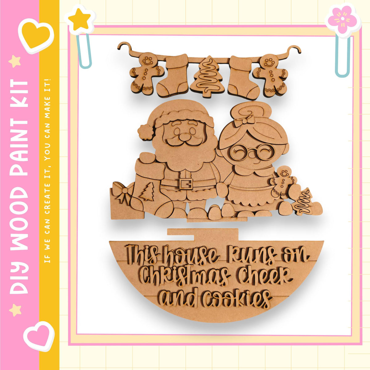 A wooden Christmas-themed decoration kit featuring a Santa Claus and a woman, along with a sign that says "This house runs on Christmas cheer and cookies".