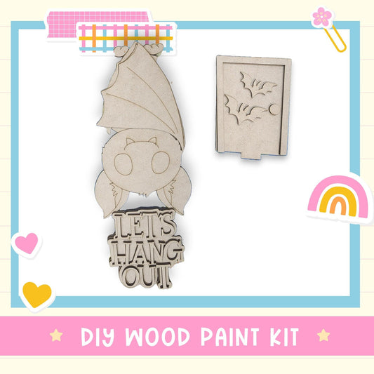 a DIY wood paint kit, including a bat-shaped stencil and a wooden sign with the phrase "Let's hang out".