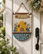 A wooden sign with a bee design hangs on a door, accompanied by a banner that says "Busy bees make sweet days".