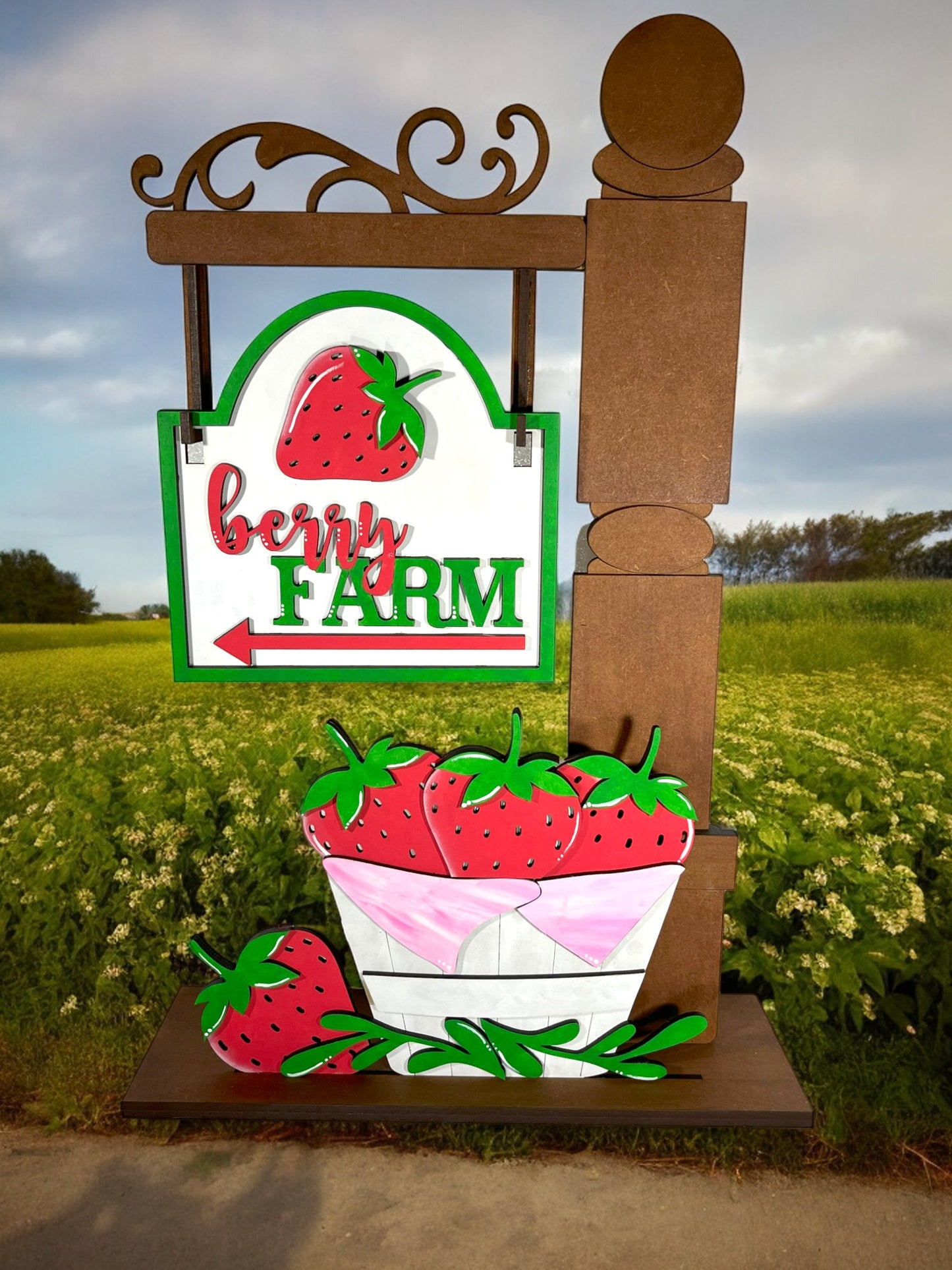 a sign for a farm with a bowl of strawberries