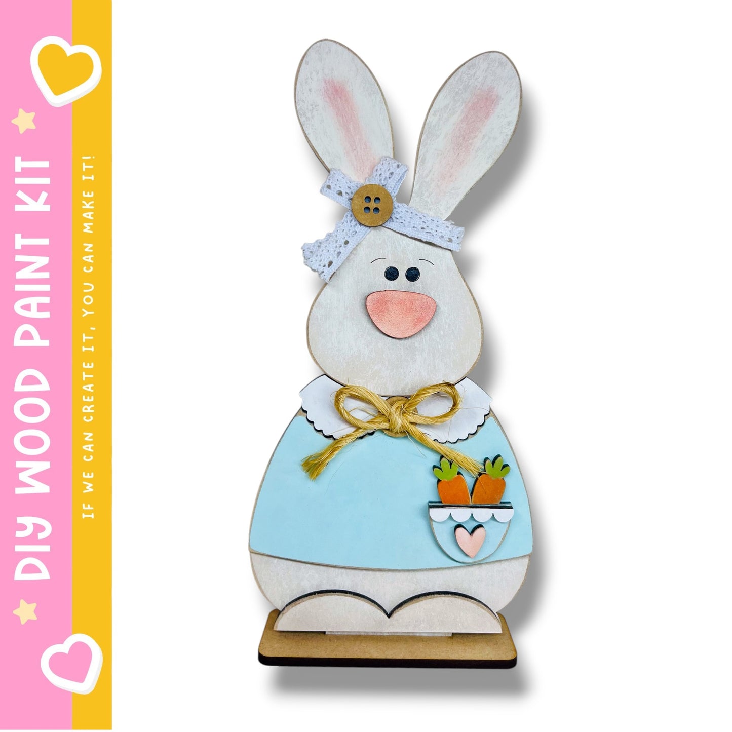 A wooden Easter bunny decoration with a blue dress, a bow, and a carrot in its pocket.