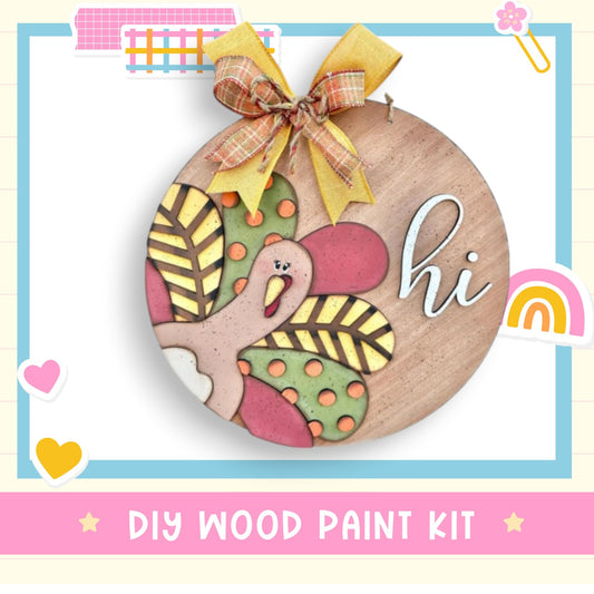 a wooden painted ornament with a bow on it