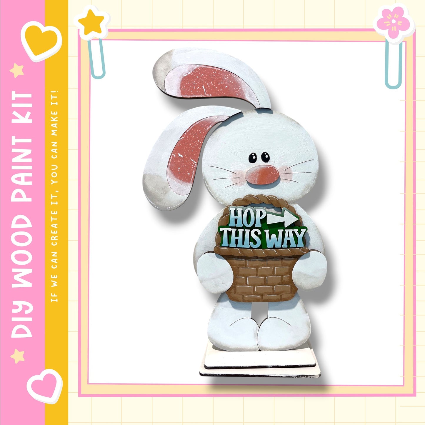 A wooden Easter bunny figurine holding a basket with the text "HOP THIS WAY" written on it.