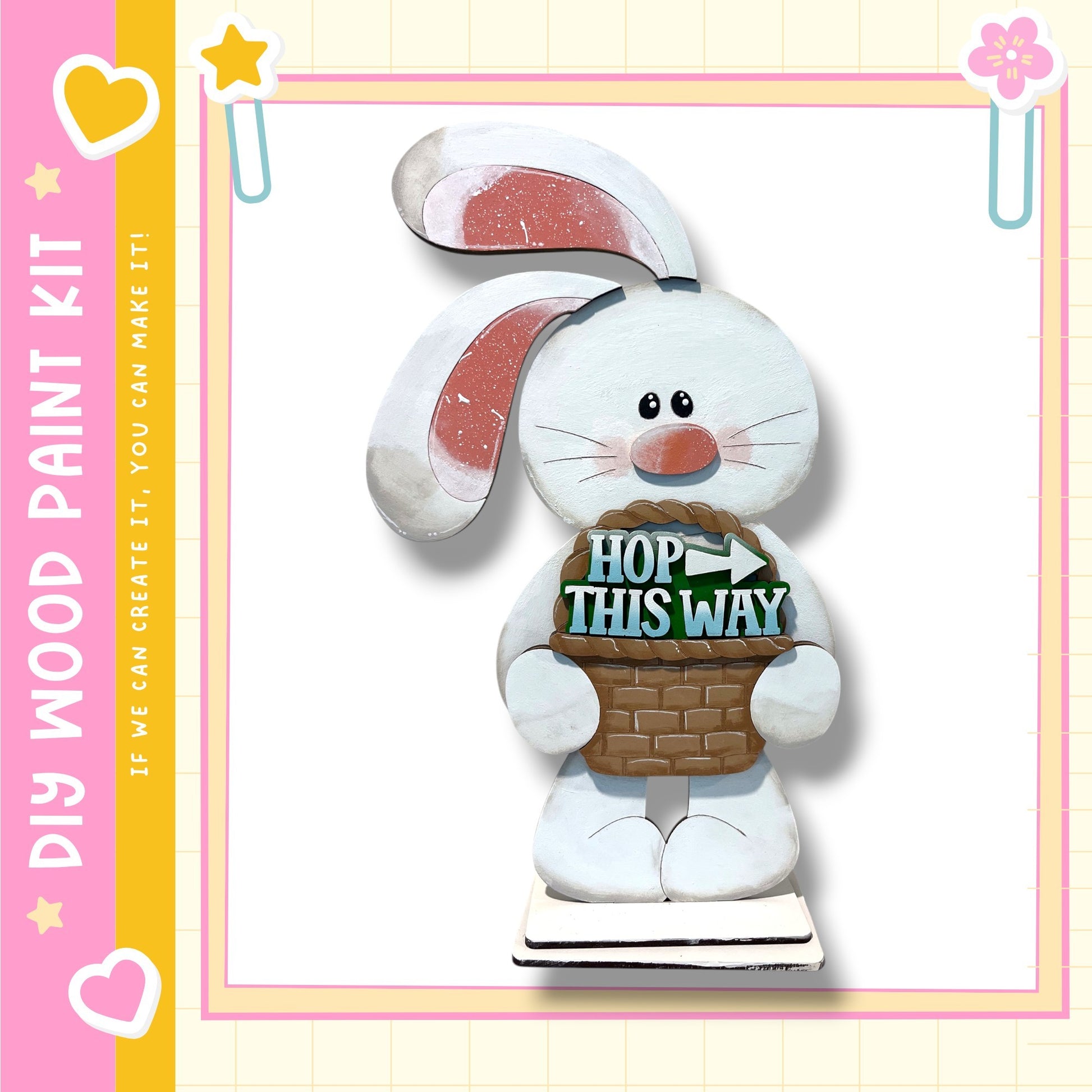 A wooden Easter bunny figurine holding a basket with the text "HOP THIS WAY" written on it.