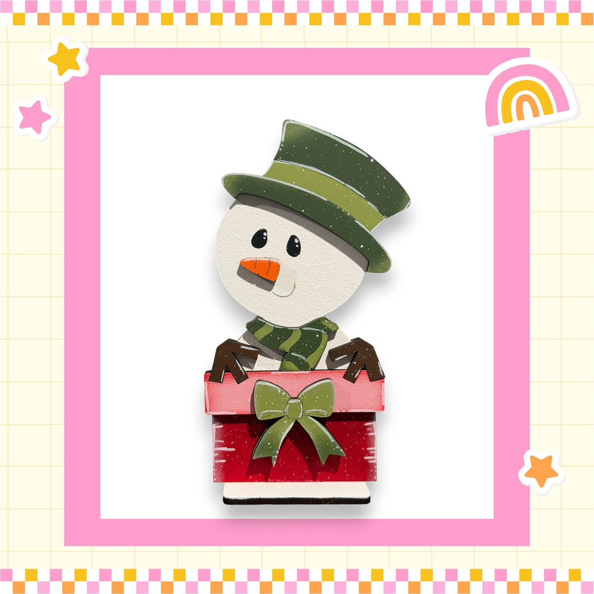 A cheerful snowman wearing a green hat and scarf, holding a red gift box with a green bow, is surrounded by a pink and yellow checkered border and stars.