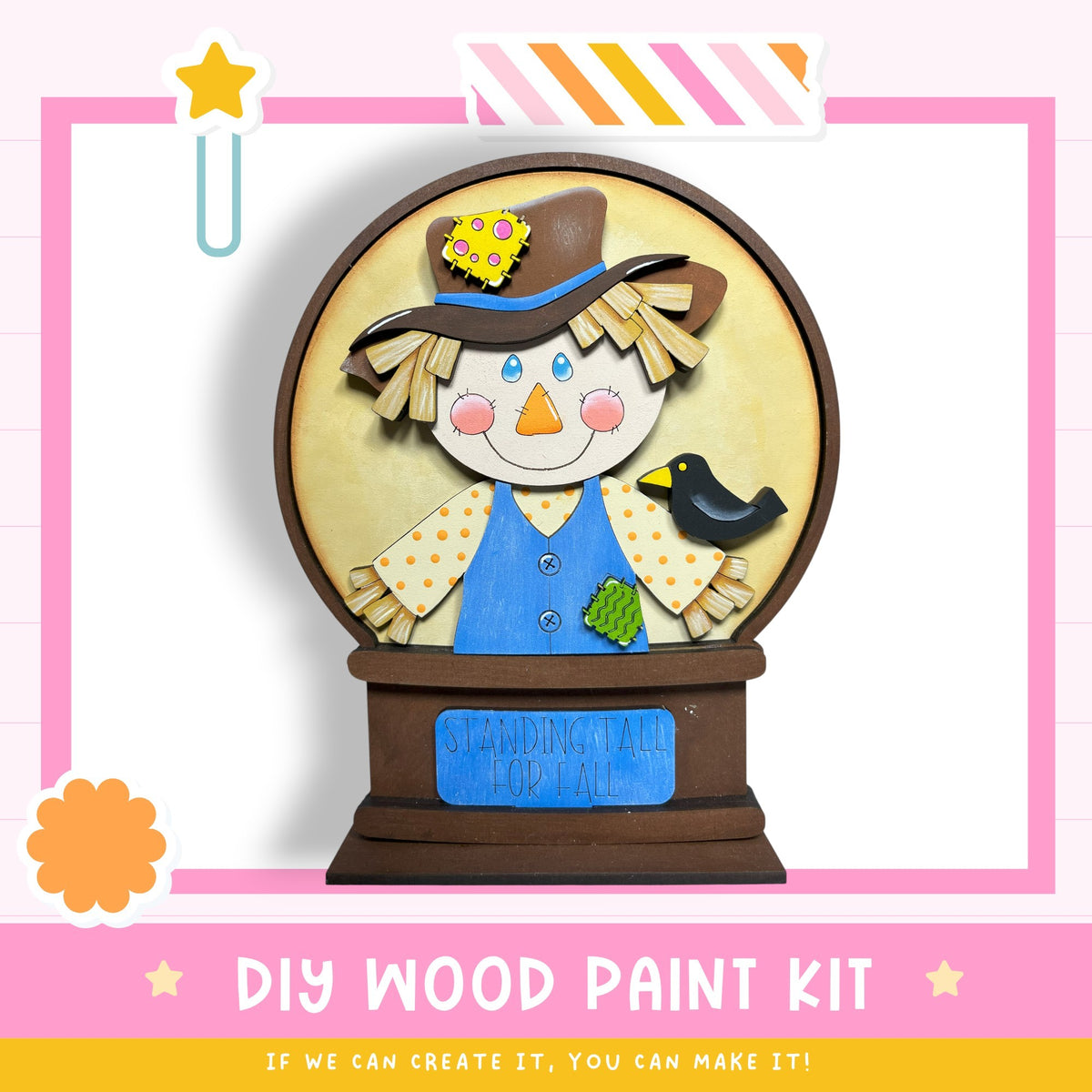 a DIY wood paint kit for creating a wooden snow globe. The kit includes a wooden base, a wooden figure of a scarecrow, and a wooden bird. The kit is designed to be used to create a decorative snow globe.