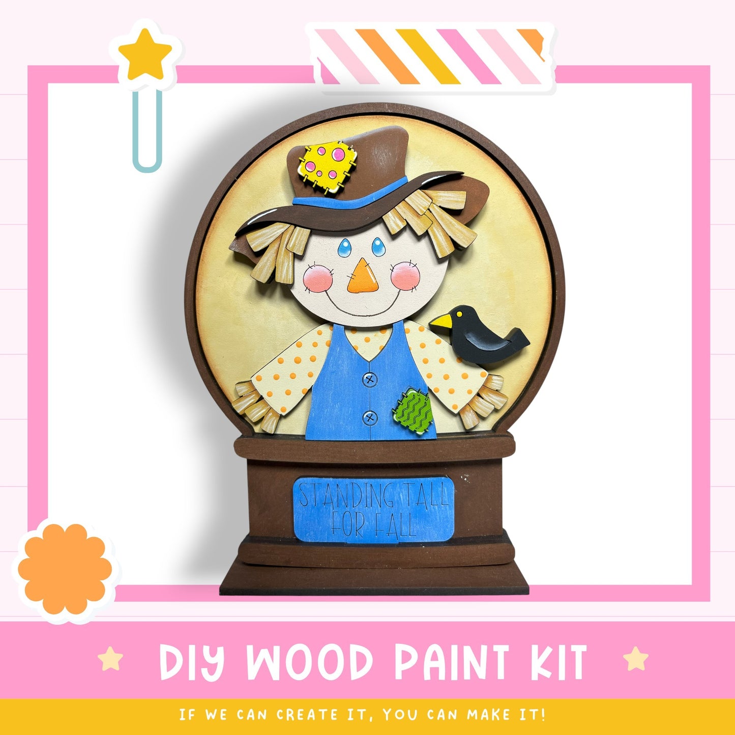 a DIY wood paint kit for creating a wooden snow globe. The kit includes a wooden base, a wooden figure of a scarecrow, and a wooden bird. The kit is designed to be used to create a decorative snow globe.