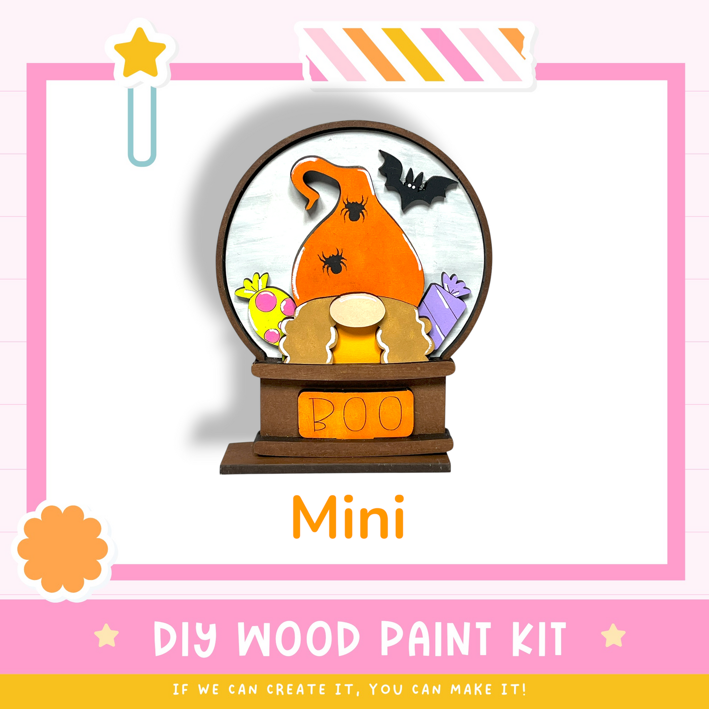 The image is a colorful and whimsical DIY wood paint kit featuring a mini pumpkin-shaped ornament with a bat and other Halloween-themed decorations. The kit is designed for creating a unique and festive decoration piece.