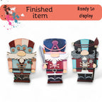three wooden figurines of different sizes and colors