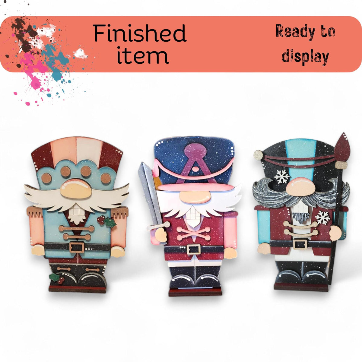 three wooden figurines of different sizes and colors