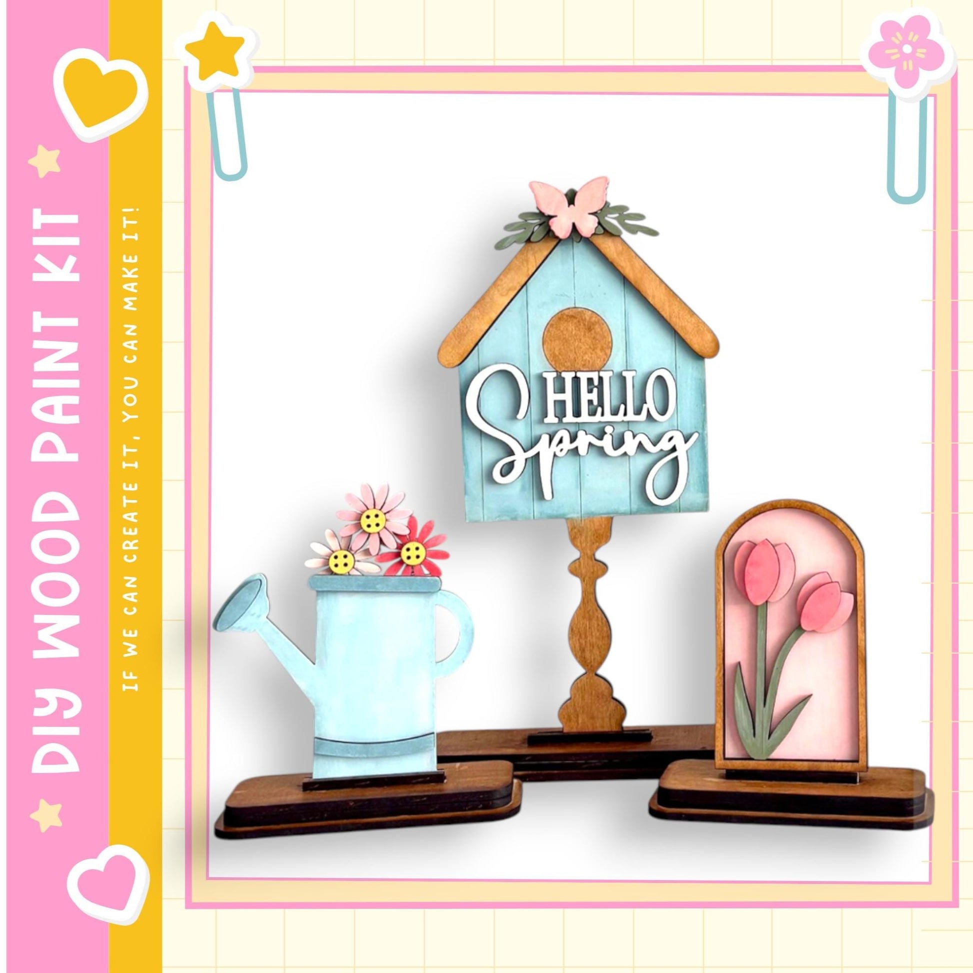 a wooden paint kit with various spring-themed items, including a birdhouse, a watering can, and a framed picture of pink tulips.