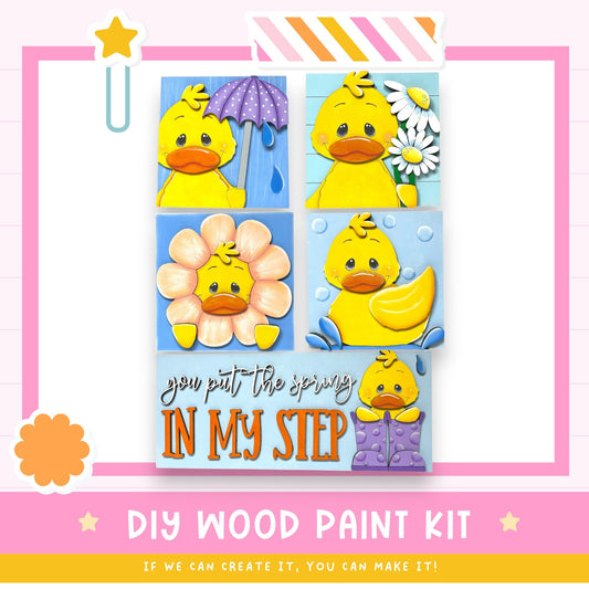 The image is a collage of four images featuring yellow duck characters in various spring-themed scenes, such as holding umbrellas, flowers, and raindrops. The collage is framed by a pink border and includes text that reads "DIY WOOD PAINT KIT" and "IF WE CAN CREATE IT, YOU CAN MAKE IT!"