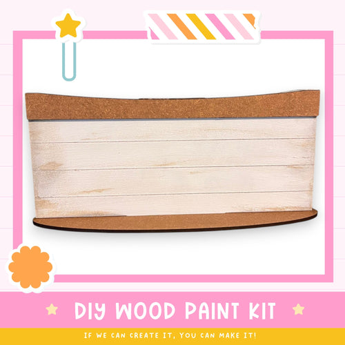The image is a DIY wood paint kit advertisement, featuring a wooden plank with a cork top and a pink and white striped border. The text "DIY WOOD PAINT KIT" is displayed, along with the tagline "IF WE CAN CREATE IT, YOU CAN MAKE IT!" The image is a collage of various other images, and the phrase "LESS THAN 500 characters" is used to describe the image.