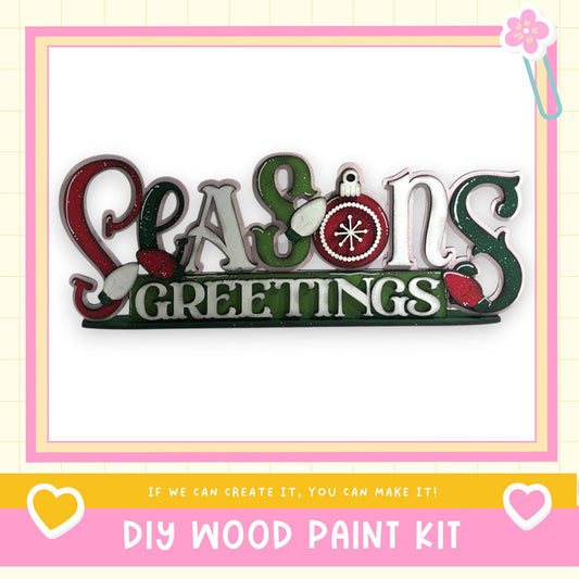 The image is a DIY wood paint kit for creating a seasonal greeting sign.