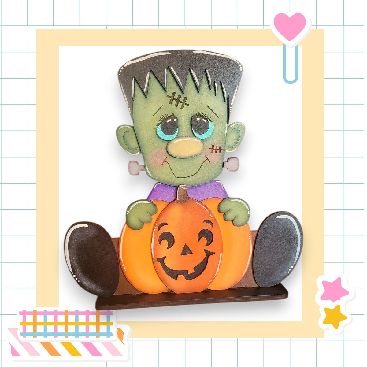 A carved pumpkin with a carved face and a green monster figure holding it, set against a grid background with a heart and a star.