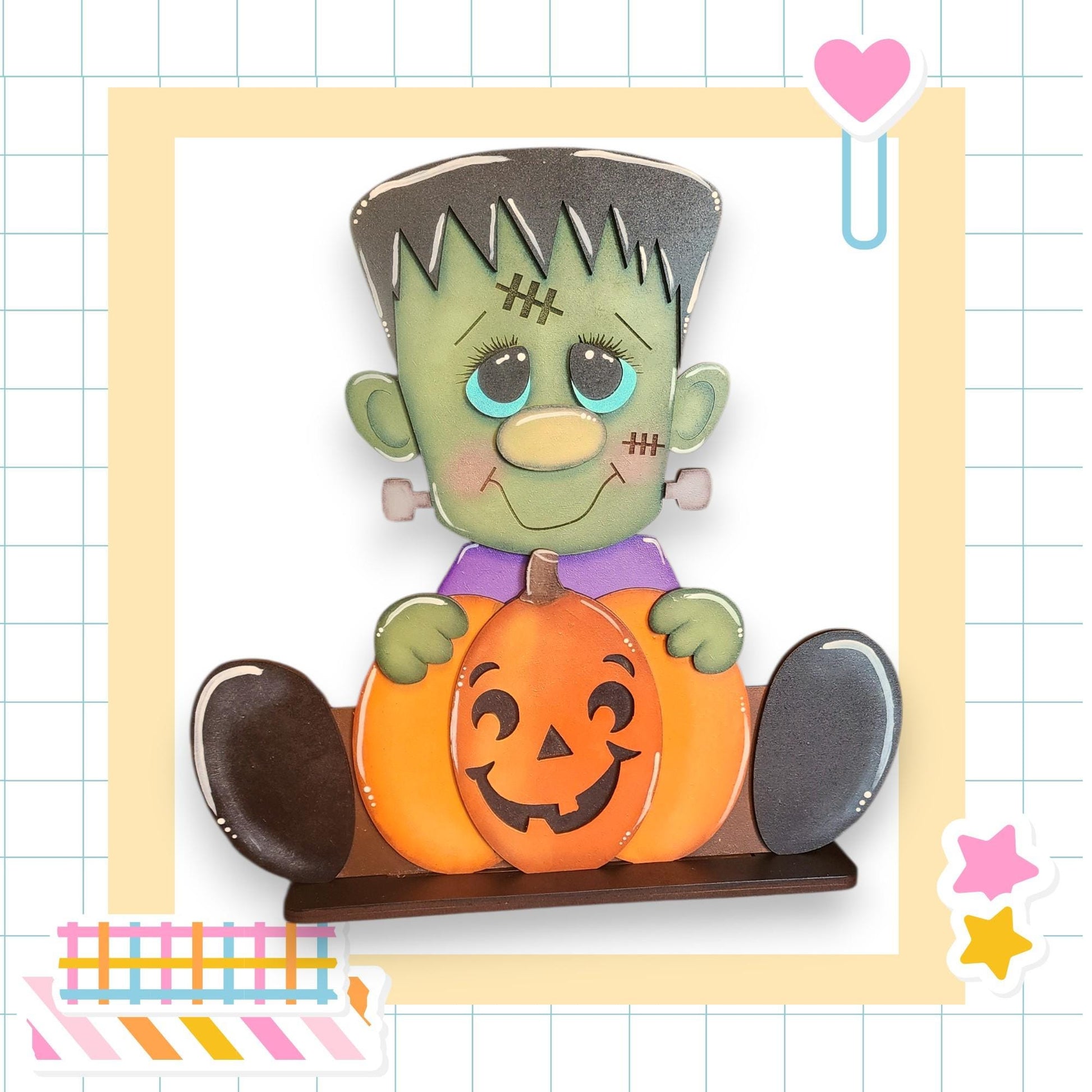 A carved pumpkin with a carved face and a green monster figure holding it, set against a grid background with a heart and a star.