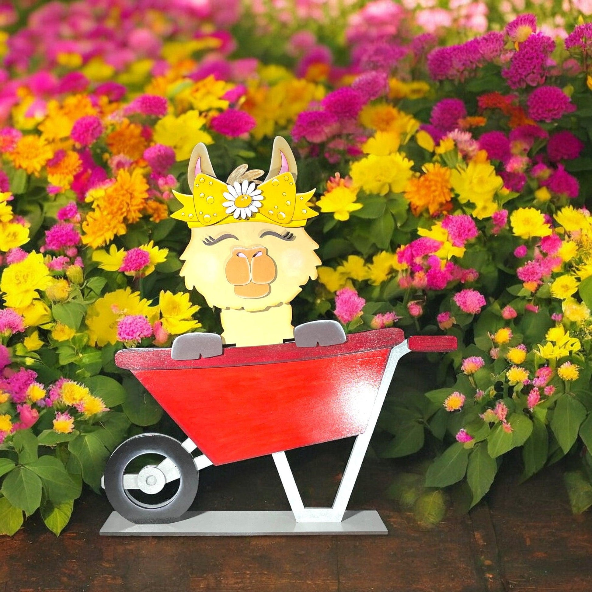 a wooden toy of a llama in a wheelbarrow surrounded by flowers