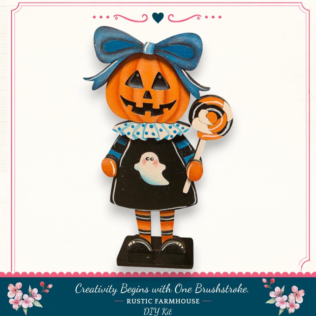 A Halloween-themed pumpkin figurine with a bow, holding a lollipop, and wearing a black dress with a ghost design.