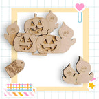 Halloween-themed wooden cutouts, including jack-o-lanterns and ghostly figures, arranged in a playful and festive manner.