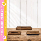 three wooden blocks or stands placed on a wooden surface, with a pink and yellow striped border on the left side.