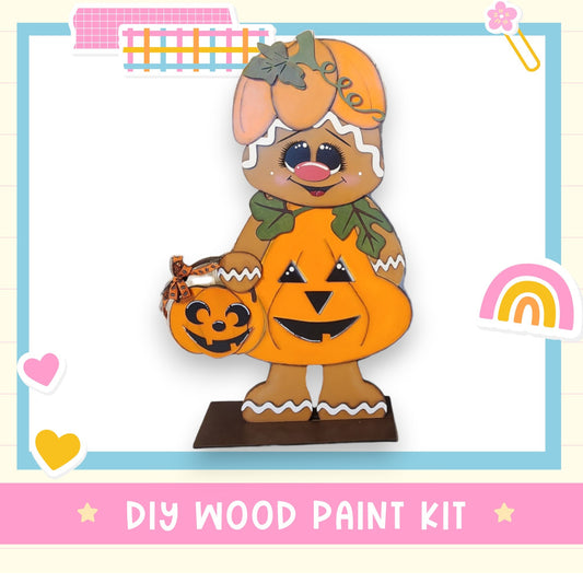 a wooden cutout of a dog holding a pumpkin