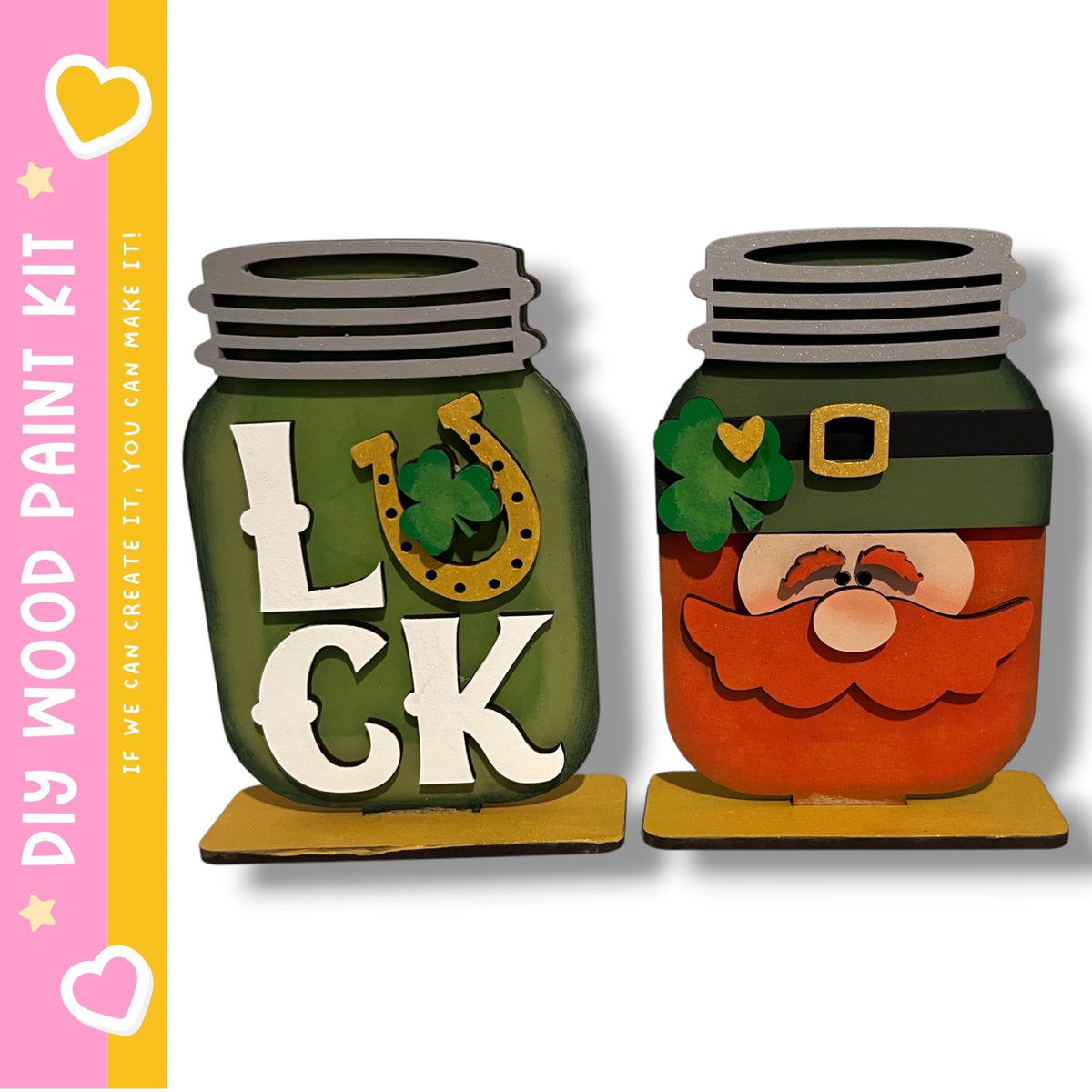 two mason jars with painted designs on them, including a green jar with the word "LUCK" and a red jar with a smiling face and a clover.