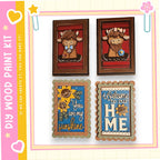 four wooden frames with various designs and text, including a cow, a sunflower, a welcome sign, and a heart.