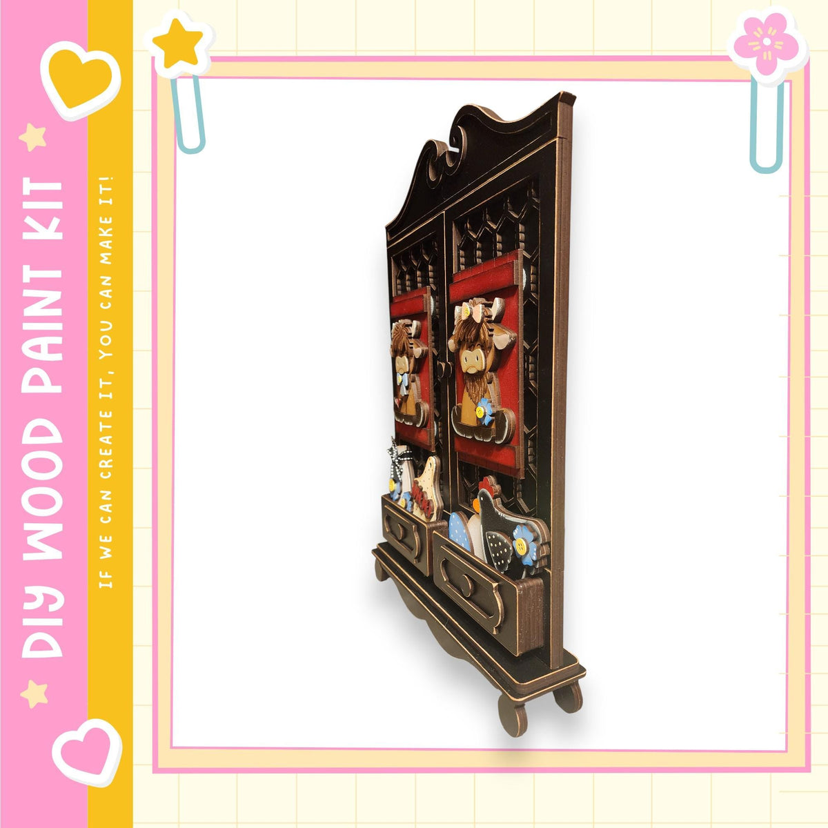 A wooden cabinet with decorative elements, such as a red curtain, a yellow star, and a pink flower, is shown in the image.