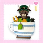 a cup of coffee with a cow in it