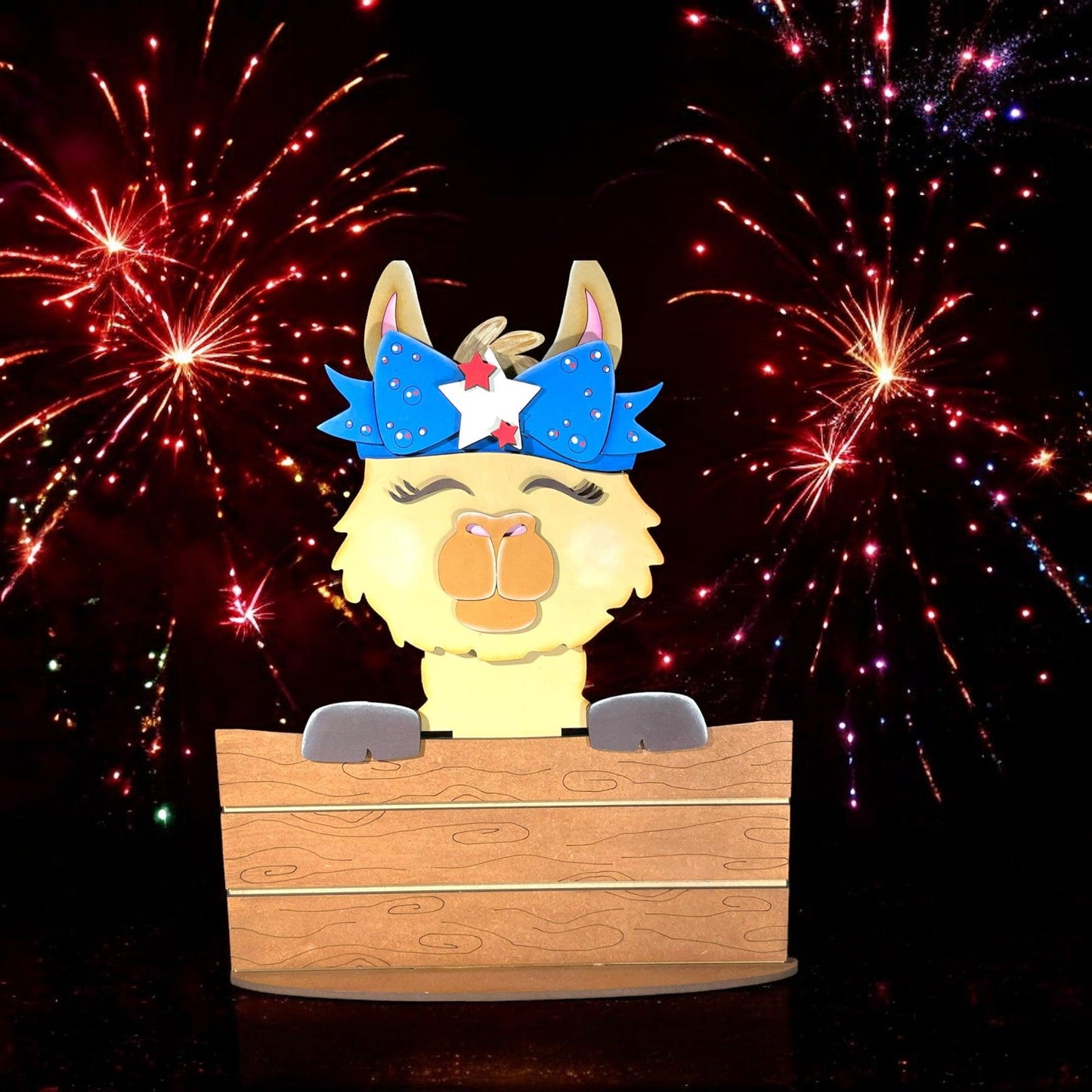 a wooden box with a llama in it and fireworks in the background