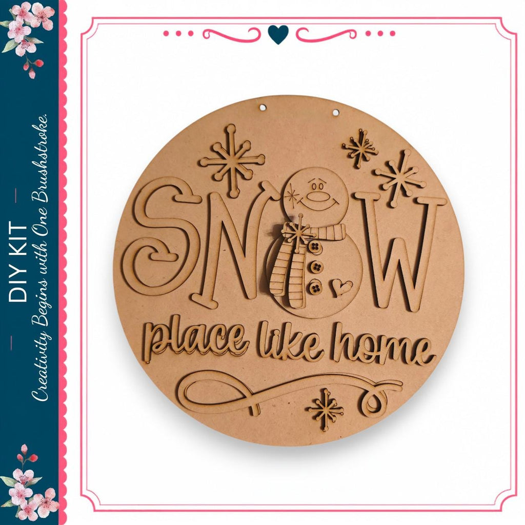 A wooden sign with the text "SNOW place like home" carved into it, featuring a snowman and snowflakes.
