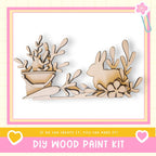 The image is a DIY wood paint kit featuring a wooden rabbit and plant decoration.