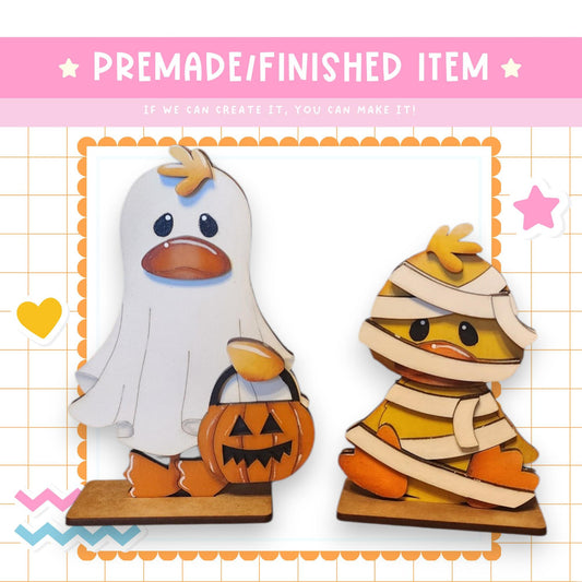 a paper cut out of a penguin and a ghost