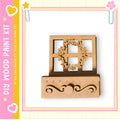 a wooden wreath and a wooden shelf, both of which appear to be part of a DIY paint kit.