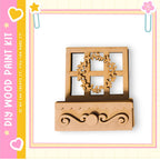 a wooden wreath and a wooden shelf, both of which appear to be part of a DIY paint kit.