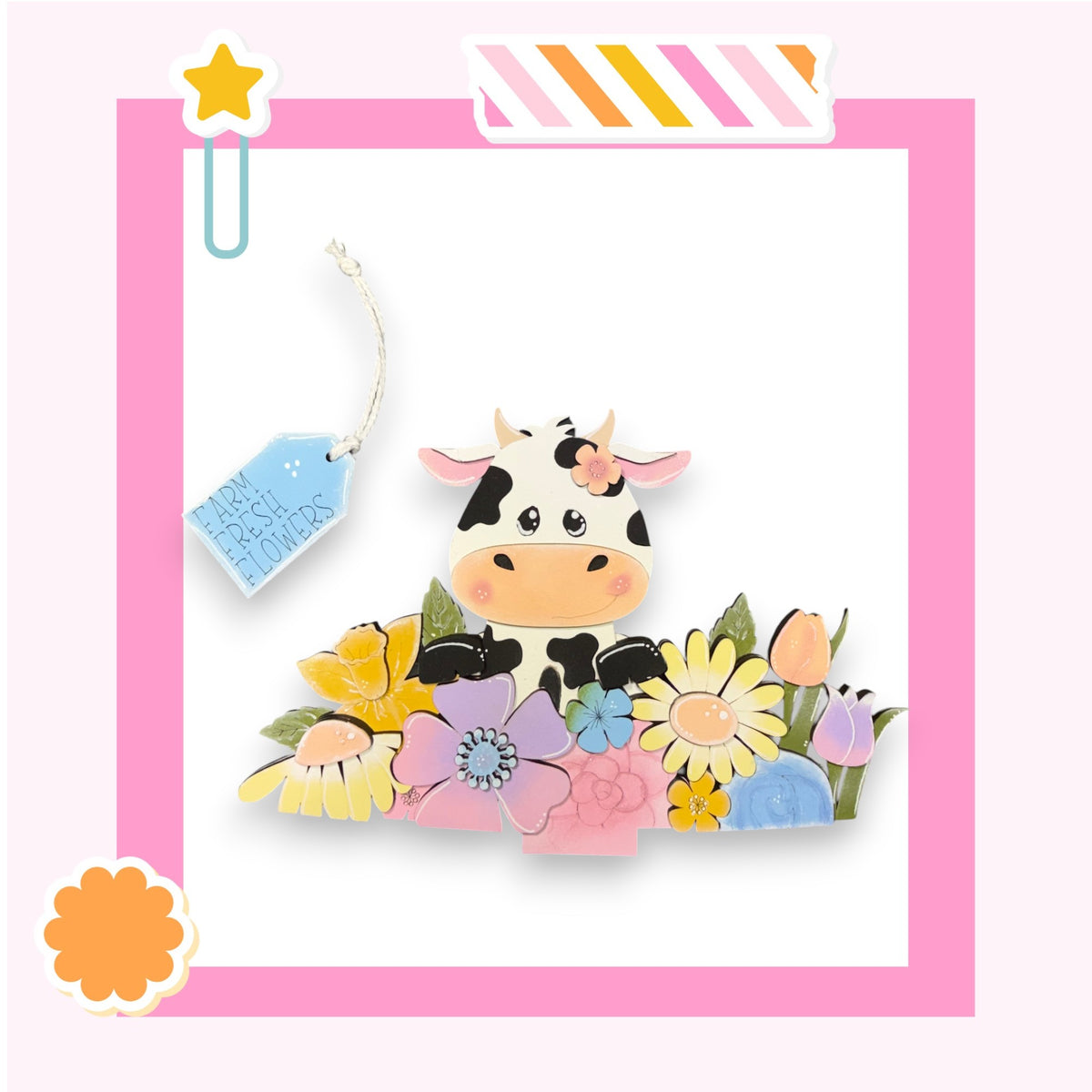 A colorful illustration of a cow surrounded by a variety of flowers and plants, with a pink border framing the scene.