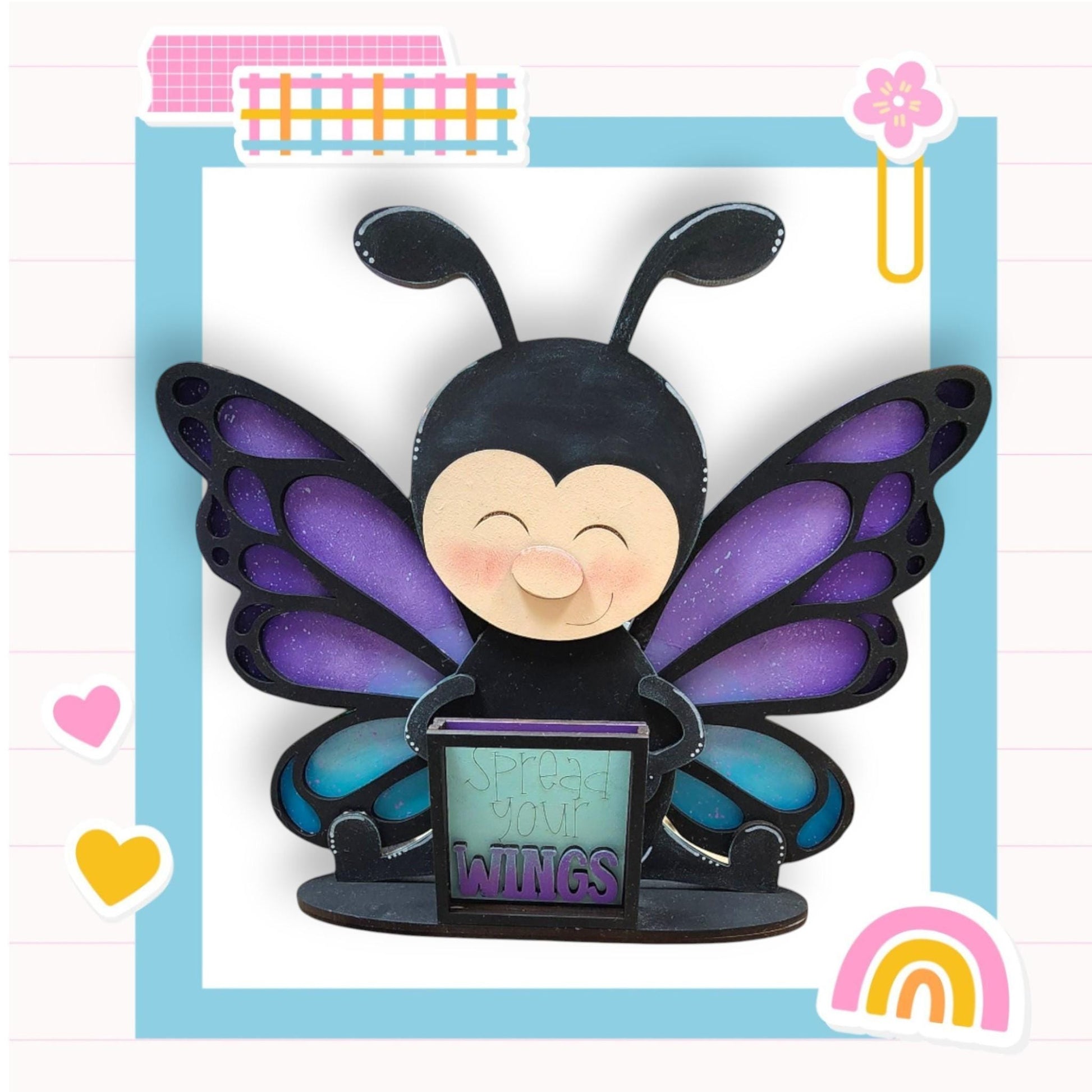 a paper sculpture of a butterfly holding a laptop