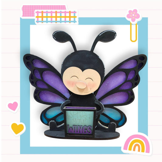 a paper sculpture of a butterfly holding a laptop