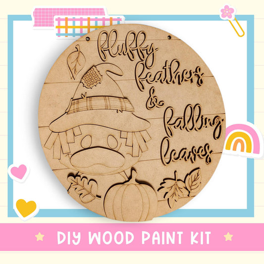 a DIY wood paint kit for creating a wooden sign with a cartoon character and fall-themed elements, such as leaves and a pumpkin.
