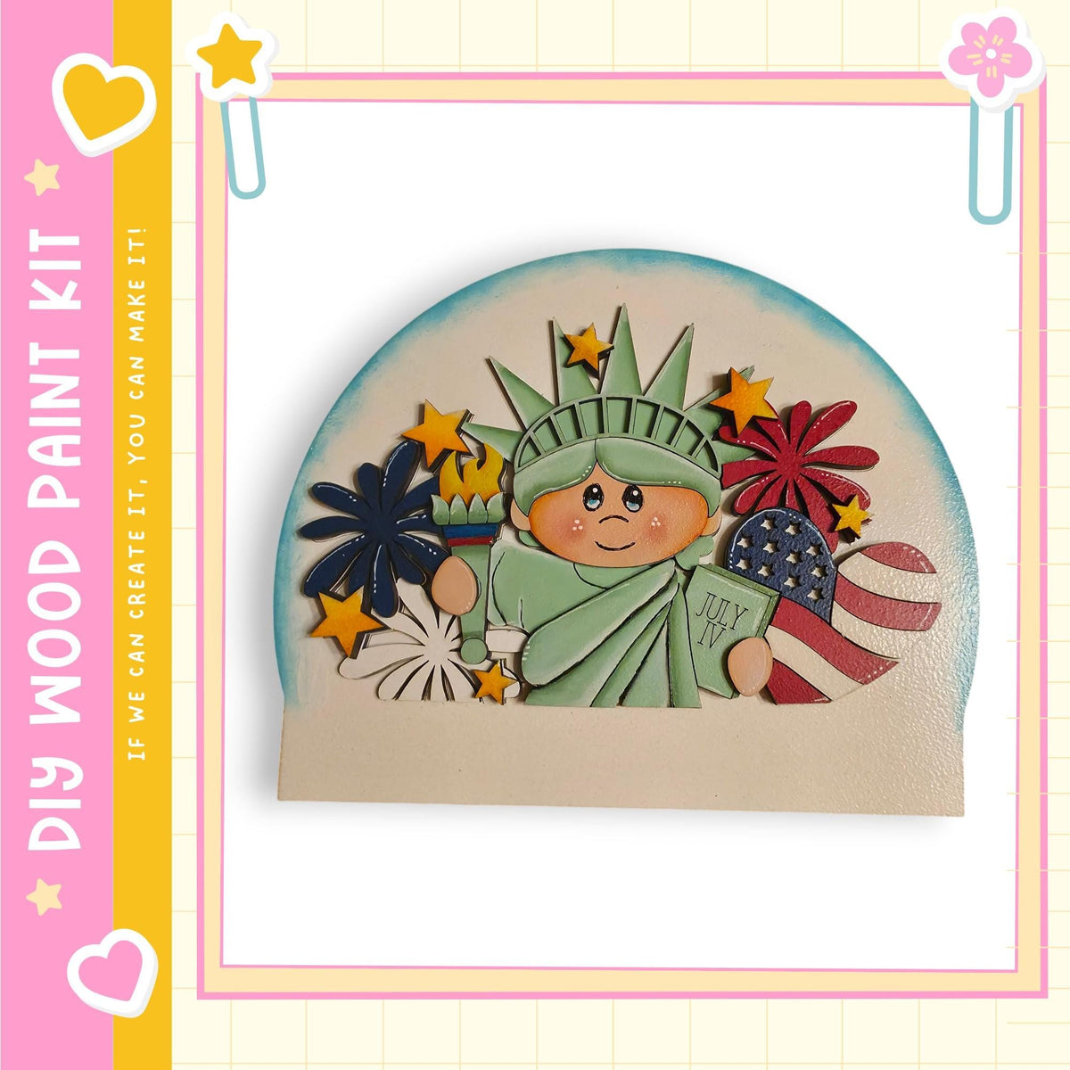 A wooden paint kit depicting the Statue of Liberty surrounded by various patriotic symbols, including a flag, fireworks, and a heart.