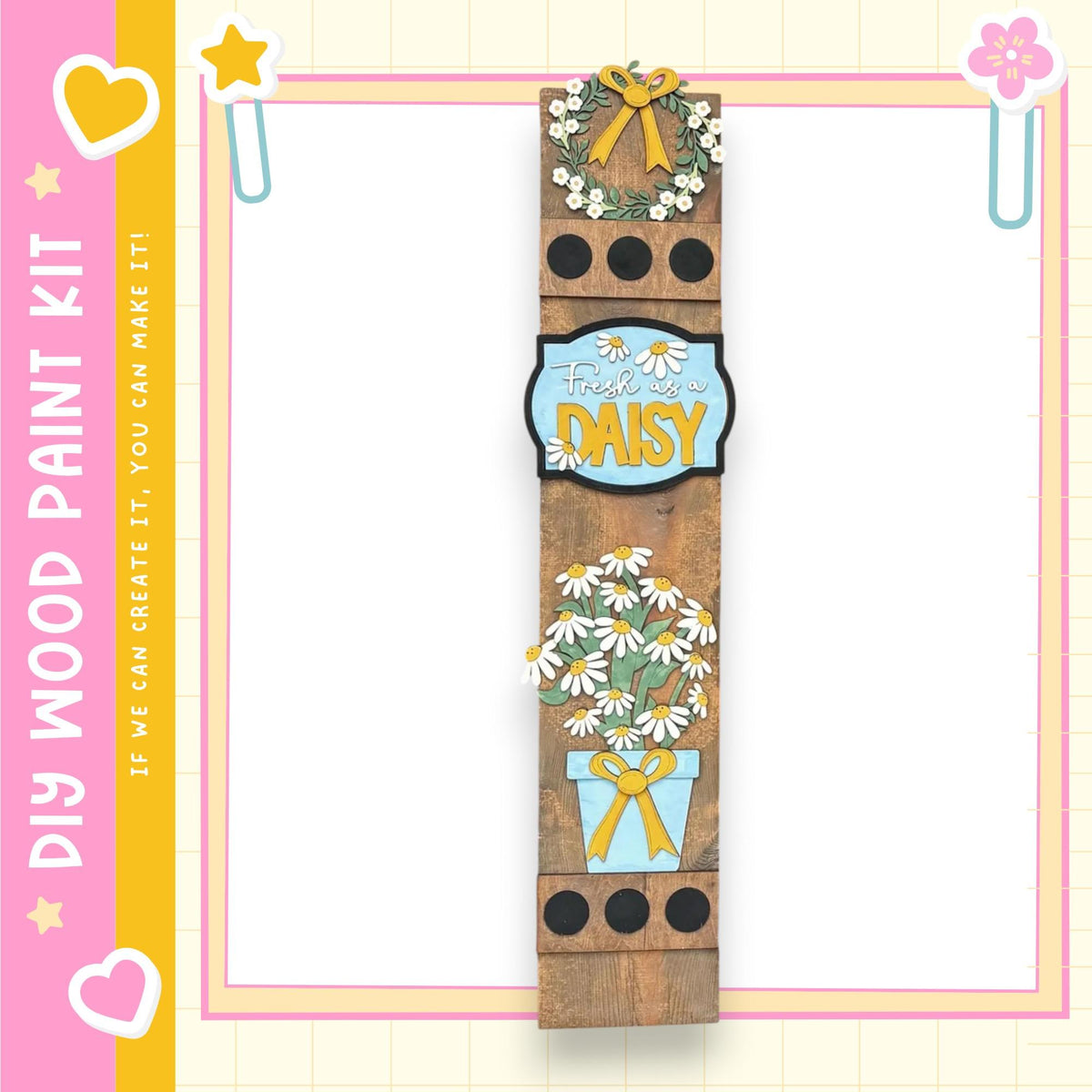 a wooden plank with various decorative elements, including a wreath, flowers, and a sign that says "Fresh as a daisy". The background is a pink and yellow color scheme with a heart and star motif.