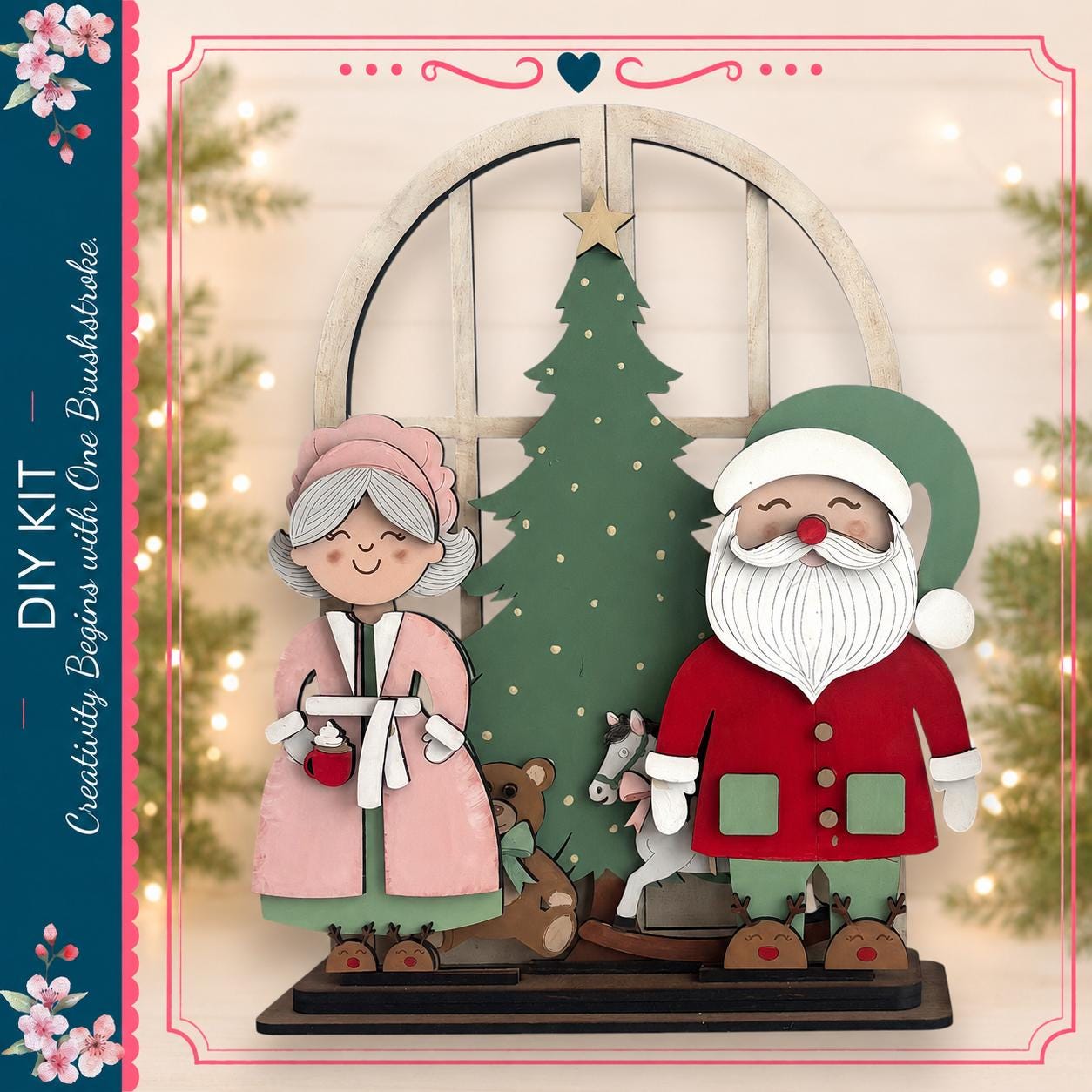 A DIY kit featuring a Christmas tree and two wooden figures, one of Santa Claus and the other of an elderly woman, likely representing the characters from the Christmas story.
