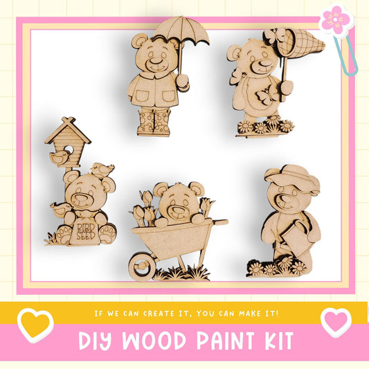 a DIY wood paint kit with various wooden animal figurines, including bears, birds, and a wagon, as well as an umbrella and a flower.