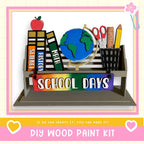 a school day craft kit with a globe, books, pencils, scissors,
