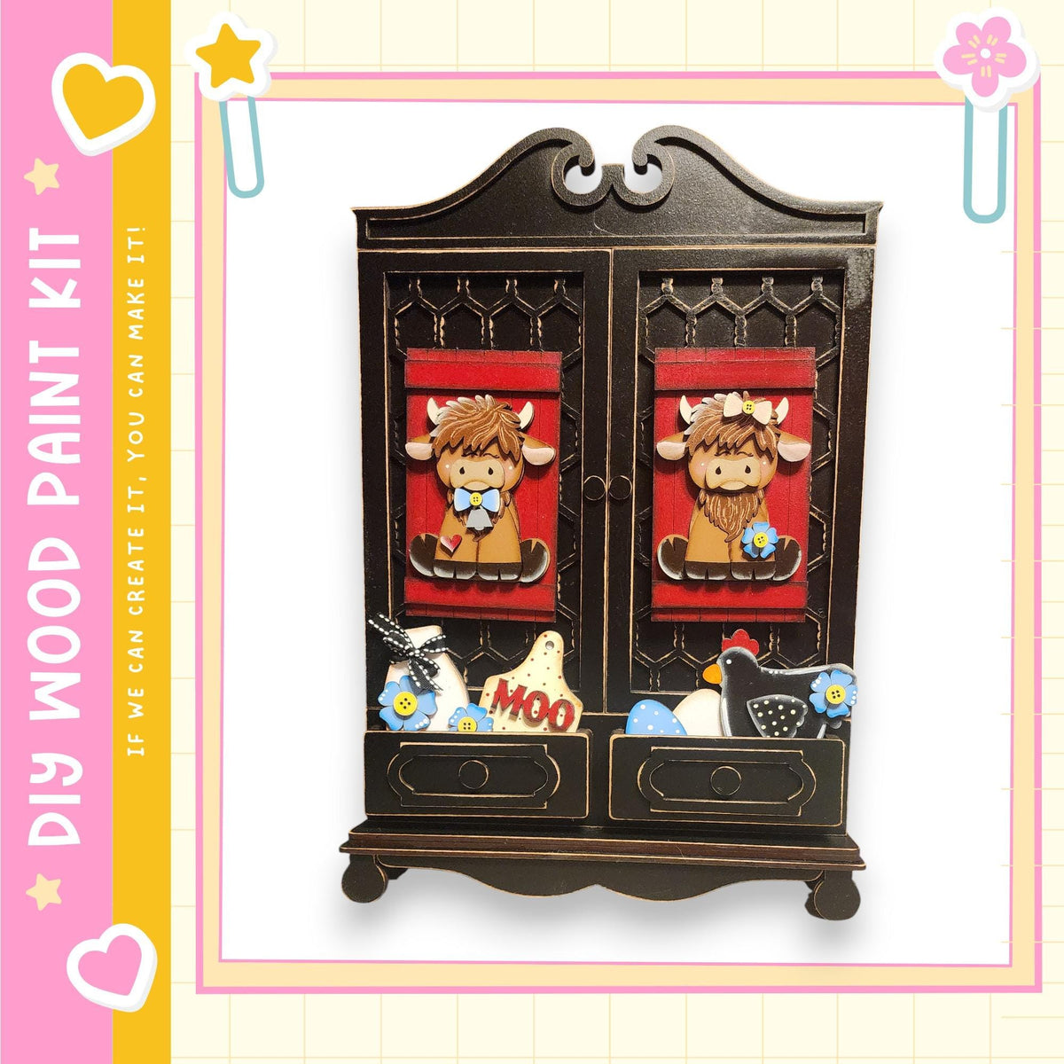 a wooden paint kit with a decorative design, including two cow-like figures and various other decorative elements.