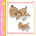two wooden duck figures, one larger and one smaller, set against a pink and yellow background.