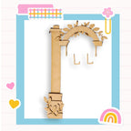 a picture of a wooden key with a rainbow in the background