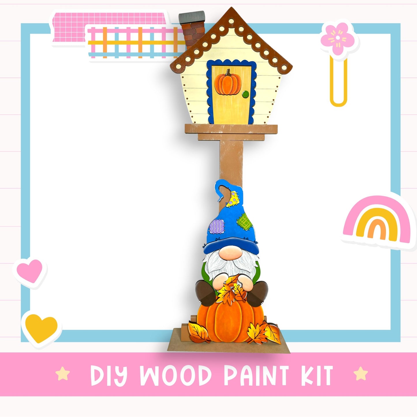 A DIY wood paint kit featuring a gnome figurine sitting on a pumpkin, with a birdhouse and other fall-themed decorations in the background.